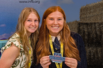 Two women smiling at the camera.