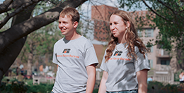 Two college-aged students walking on campus.